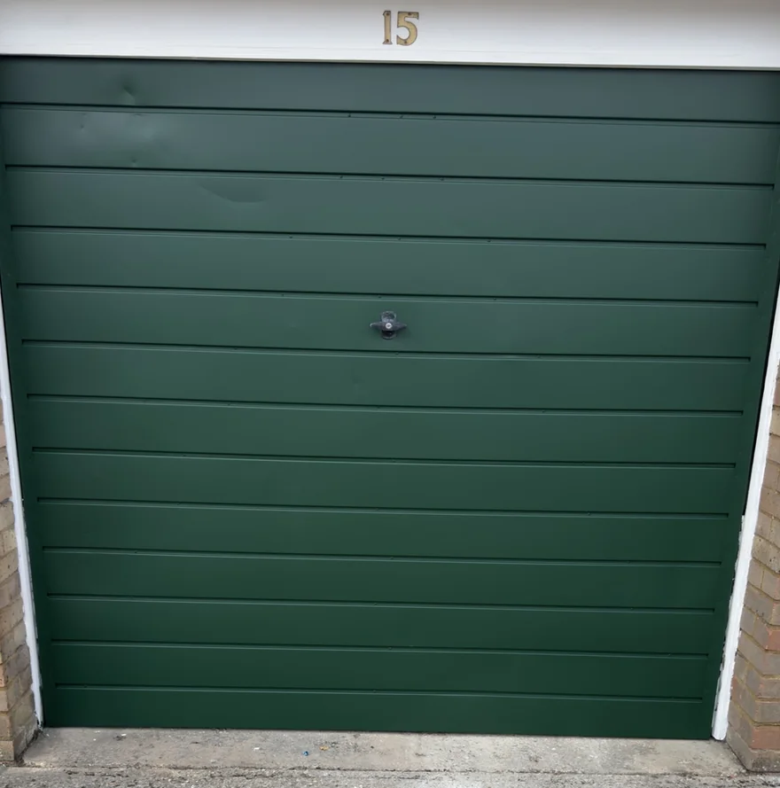 The same Bletchley garage door after respray in RAL 6005 Moss Green satin 2K direct-to-metal coating
